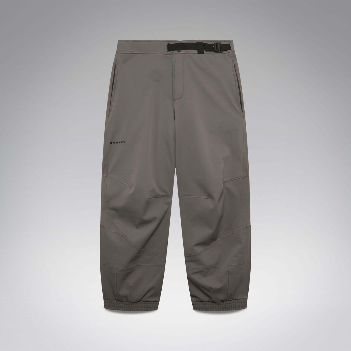 MWintertideSoftshellPant-A pair of gray snow pants with a black belt and a small black Oakley logo on the left thigh, displayed against a neutral gray gradient background.