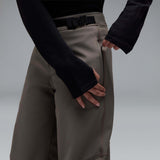 MWintertideSoftshellPant-A pair of gray snow pants with a black belt and a small black Oakley logo on the left thigh, displayed against a neutral gray gradient background.