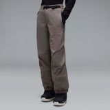 MWintertideSoftshellPant-A pair of gray snow pants with a black belt and a small black Oakley logo on the left thigh, displayed against a neutral gray gradient background.