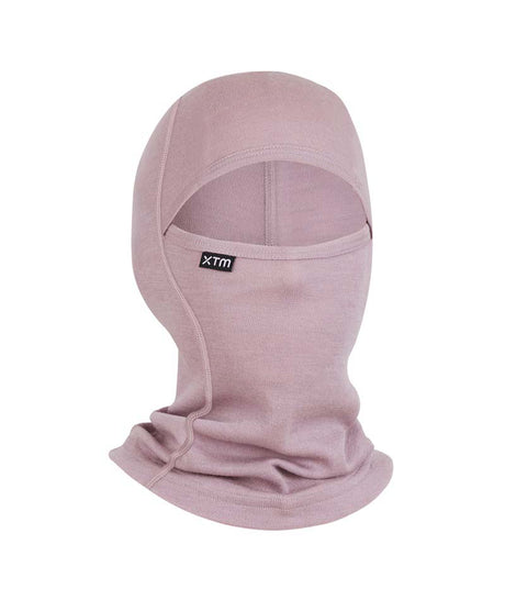 MerinoKidsBalaclava-A dusty pink balaclava face covering with a small black XTM brand tag on the side, shown against a plain white background.