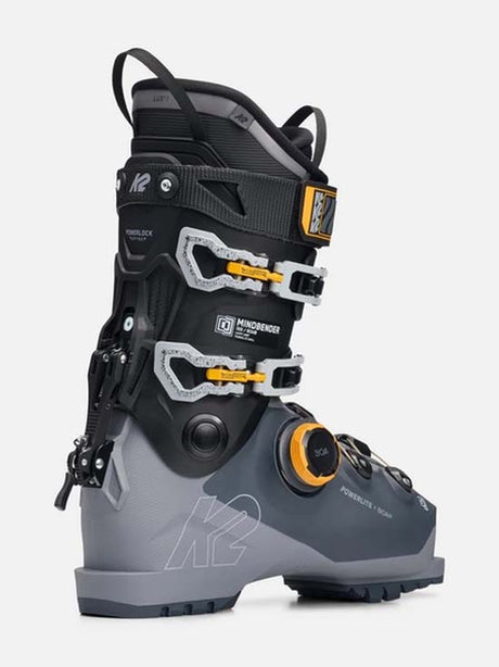 Mindbender100BOA- A K2 Mindbender ski boot in gray and black with yellow accents, shown from a side profile on a light gray background.