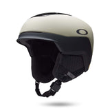 Mod5-Oakley ski helmet in off-white and black, featuring a matte finish, integrated visor, and black chin strap on a white background.