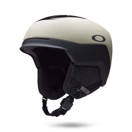 Mod5-Oakley ski helmet in off-white and black, featuring a matte finish, integrated visor, and black chin strap on a white background.