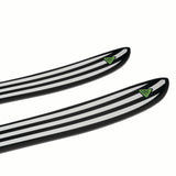 NDEPART01-Two black and white striped skis with green logos on a white background