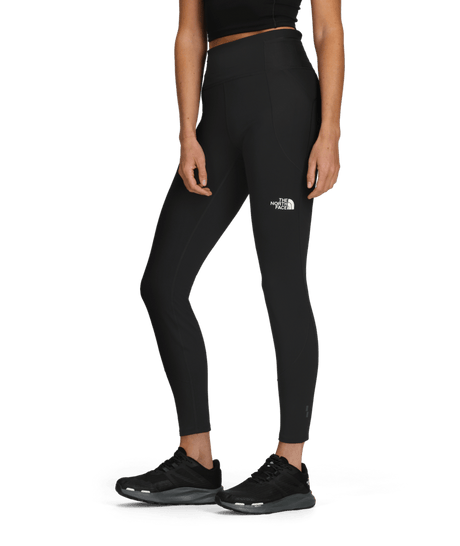 W Winter Warm Pro Tight-Person wearing black leggings with a brand logo on a transparent background