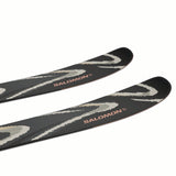 NQST94BLACK-Two black skis with white patterns and 'Salomon' branding on a white background