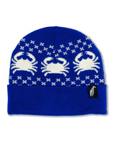 NordicrabBeanie- A royal blue knit beanie hat featuring three white knitted crabs and small white X patterns, with a folded cuff and a small black brand tag on the side.