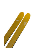Optic104-Yellow skis with branding on a white background