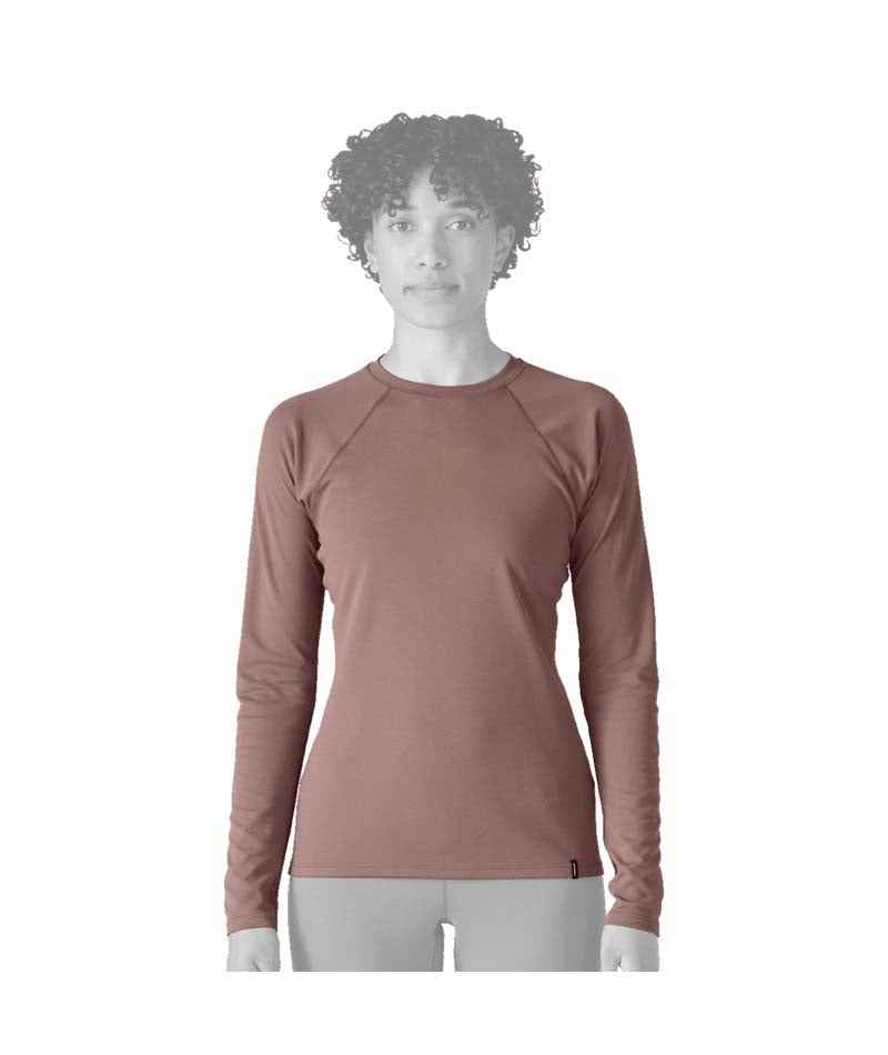 Patagonia Capilene Midweight Womens Crew- Person wearing a light pink long-sleeve shirt on a white background