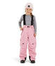 PlutoIIKidsPant-A young child wearing pink snow pants with black suspenders, a gray long-sleeve shirt, a light pink beanie, and black boots, standing against a plain white background.