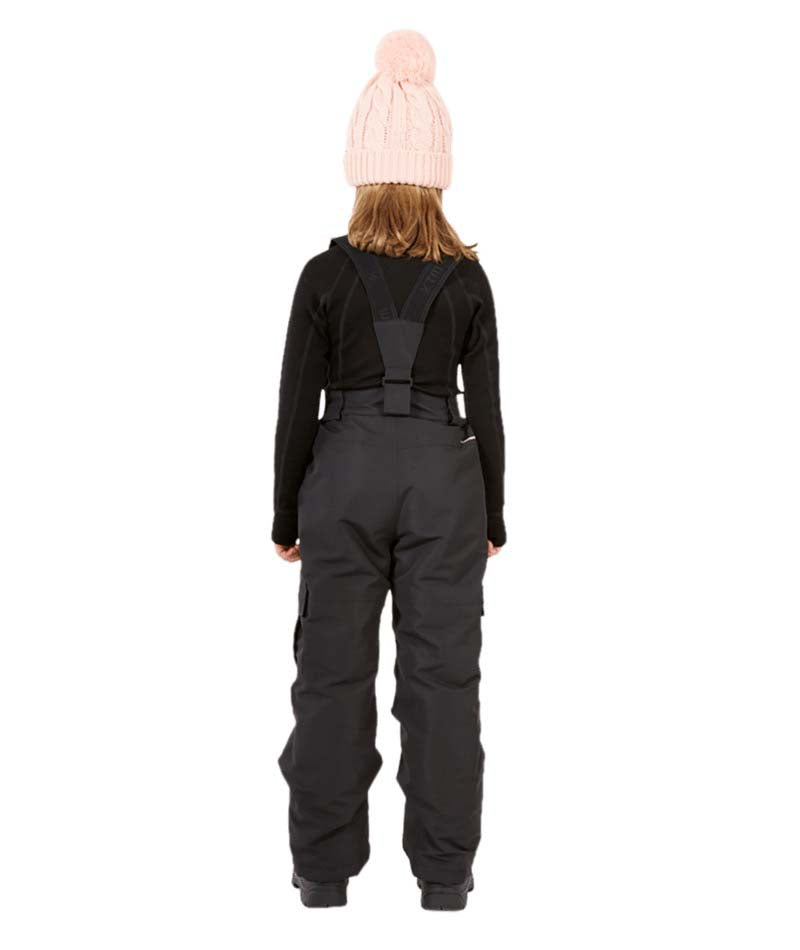 PlutoIIKidsPant-A child shown from the back wearing a light pink knit beanie with a pom-pom, a black long-sleeve top, and dark gray snow bib overalls with a black harness strap, set against a plain white background.
