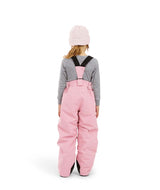 PlutoIIKidsPant-A child shown from the back wearing pink snow bib overalls with black shoulder straps, a gray long-sleeve shirt, and a light pink beanie on a white studio background.