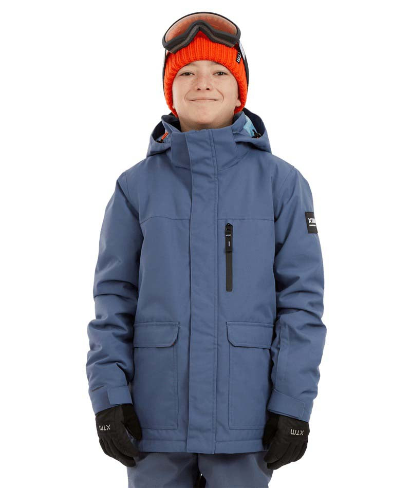RumbleJacket- A child wearing a blue snowboard jacket, black gloves, and an orange beanie with ski goggles on a white background.