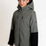 SquallKidsInsulatedJacket-A girl modeling a hooded ski jacket in a colorblock design of dark gray and black, with a small K2R logo on the left sleeve, shot against a plain white studio background.