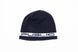 StretchLogoSkully- A dark navy blue knit beanie hat featuring a white horizontal band around the lower half with the word 'PUBLIC' in navy lettering, shown against a plain white background.