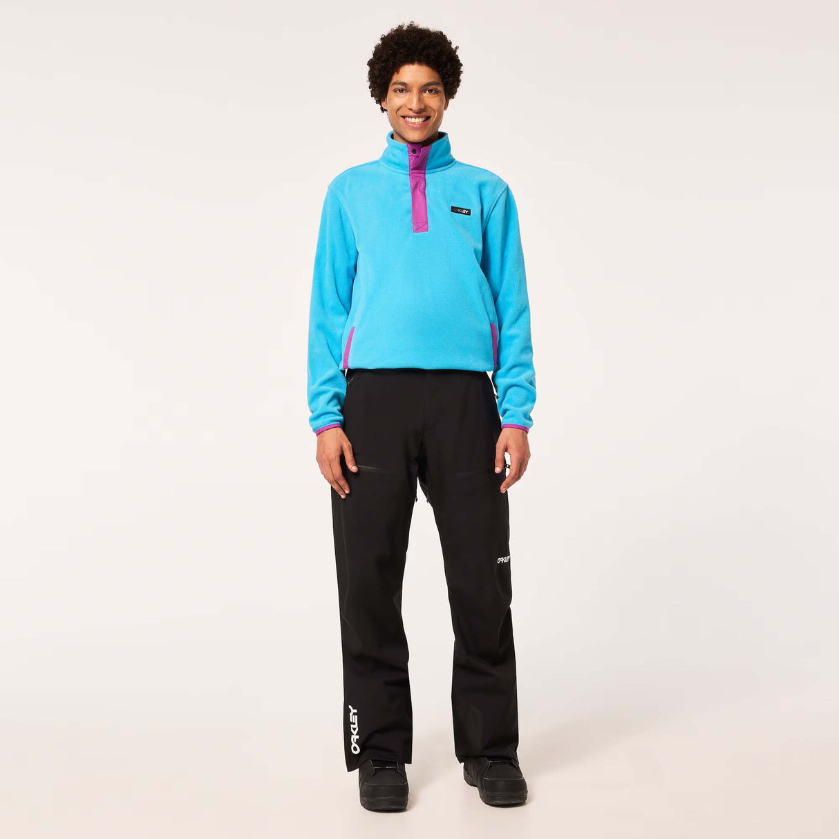 TNPShellPant2.0-Black pants with a brand logo on a light gray background