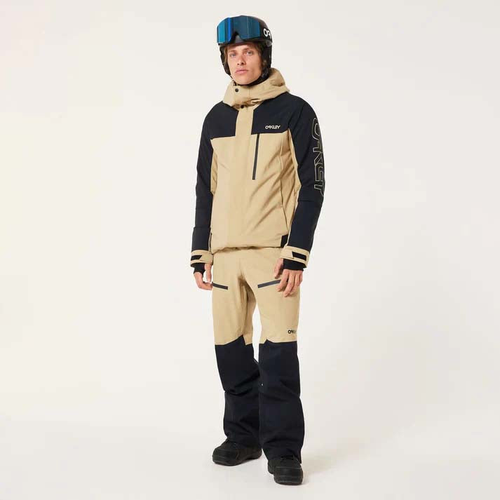 TNPShellPant2.0-Beige and black pants with a brand logo on a light gray background