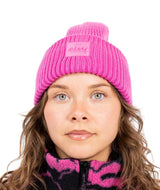 TonalBeanie- Woman wearing a white beanie on a white background