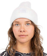 TonalBeanie- Woman wearing a white beanie on a white background