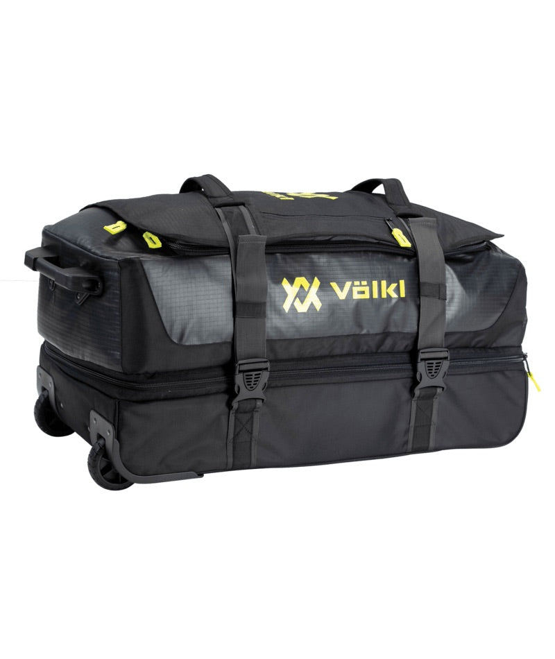 VolklRolling30AllProDuffel- A black Volkl duffel bag with a wheeled suitcase base, featuring gray side panels, black straps, and yellow logo accents on a white background.