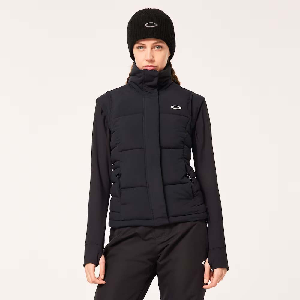 WAutumnRCVest-Person wearing a black puffer vest with a brand logo on a light gray background