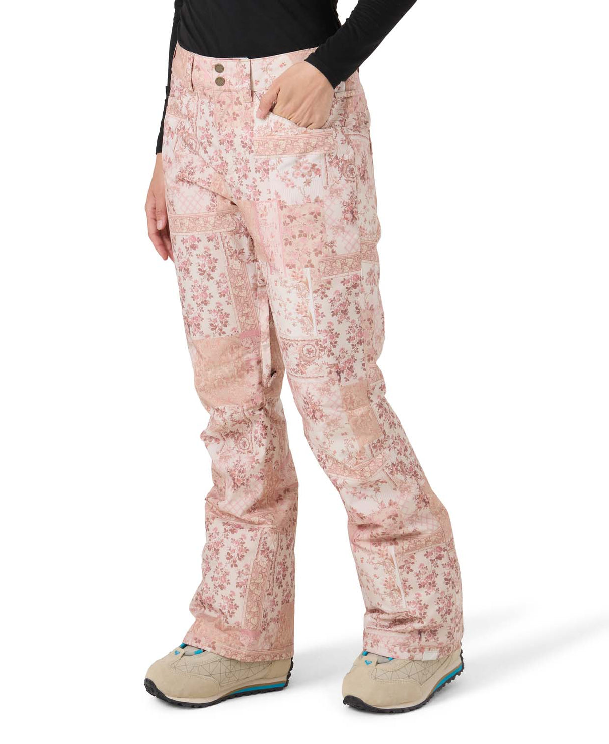 WBackyardPant- Woman wearing light pink snow pants with a floral design on a white background