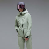 WCanopyInsulatedJacket-A light sage green hooded jacket with black zipper and drawstring details, displayed on a neutral gray background. The Oakley logo is visible on the left chest.
