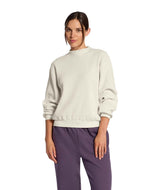 WChabot2.0MockNeck-Woman wearing a beige ribbed mock-neck sweater on a white background