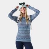 WClassicThermalMerinoBaseLayerCrew- A women's long-sleeve crewneck sweater featuring a horizontal Nordic and Fair Isle style pattern in slate blue, teal, and white.