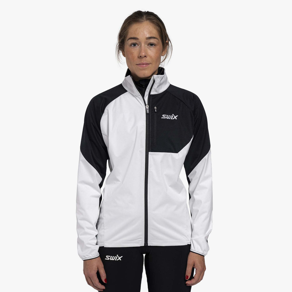 WFocusJacket- A women's colorblock athletic jacket from Swix, featuring a white body, black shoulders and upper chest, and a black front zipper, shown on a plain white background.