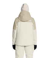WFreedomInsulatedJacket-Person wearing a light-colored snowsuit with a hood on a white background