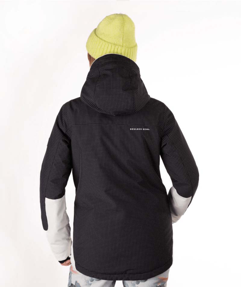WIvieJacket-Person wearing a black and white jacket with a yellow beanie on a white background