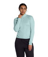 WJaida1_4Zip- Woman wearing a light blue long-sleeve quarter zip shirt on a white background