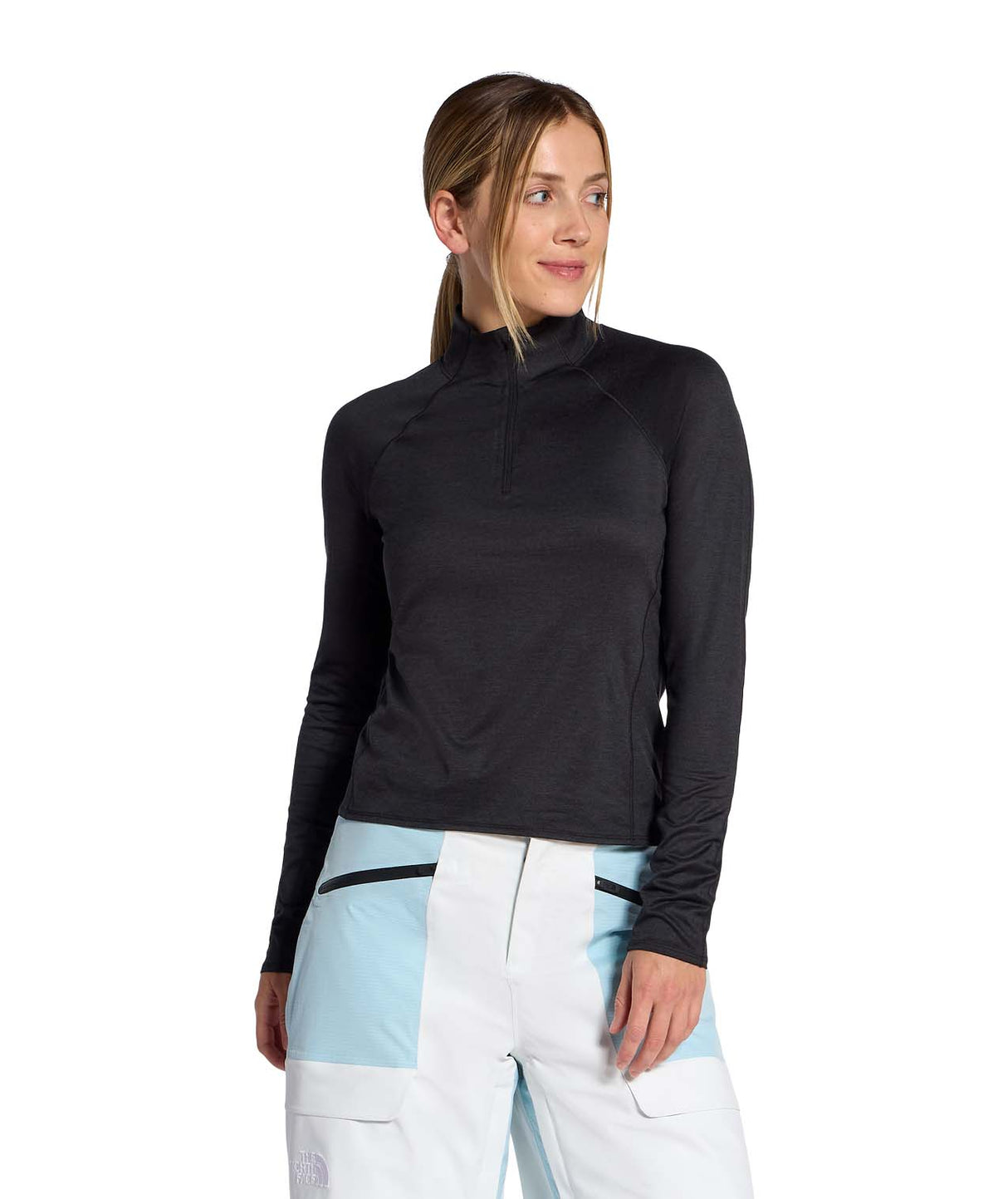 WJaida1_4Zip- Womans wearing a black long-sleeve quarter zip shirt on a white background
