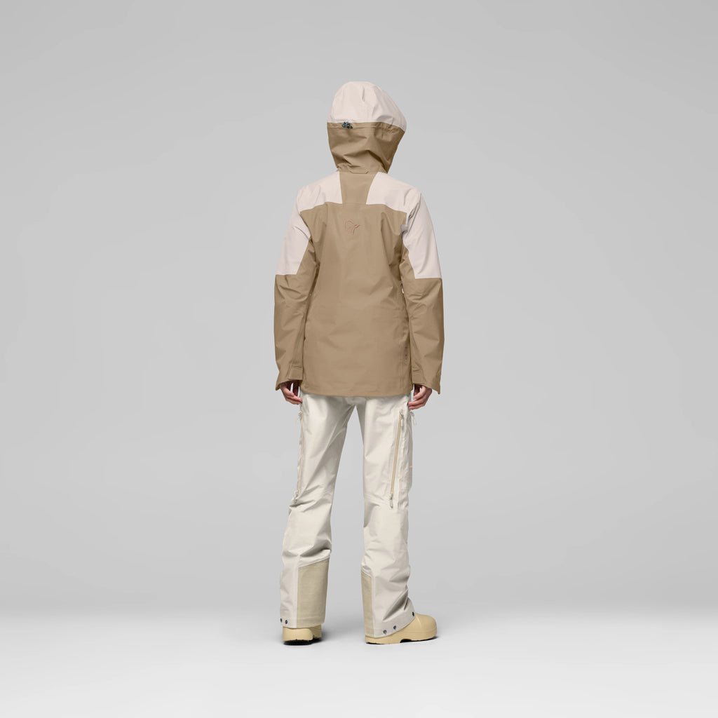 WLofotenGore-TexJkt-Person wearing a two-tone jacket and pants on a gray background