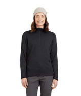 WMerinoAeroGridFleece-A woman wearing a dark charcoal ribbed quarter-zip pullover sweater, gray pants, and a light gray beanie, standing against a solid white background.