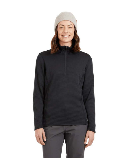 WMerinoAeroGridFleece-A woman wearing a dark charcoal ribbed quarter-zip pullover sweater, gray pants, and a light gray beanie, standing against a solid white background.