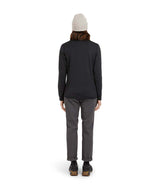 WMerinoAeroGridFleece-A woman wearing a dark charcoal ribbed quarter-zip pullover sweater, gray pants, and a light gray beanie, standing against a solid white background.