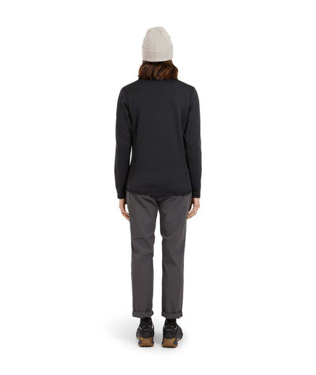 WMerinoAeroGridFleece-A woman wearing a dark charcoal ribbed quarter-zip pullover sweater, gray pants, and a light gray beanie, standing against a solid white background.