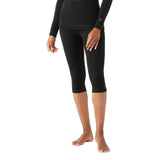 WMerinoBaselayer3_4Pant-Person wearing black long-sleeve top and capri leggings on a white background