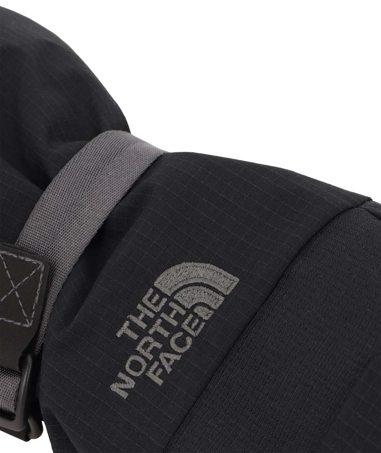 WMontanaMitt-Close-up of a black mitt with The North Face logo on a white background