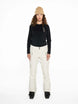 WMula2LInsulatedPant-Woman wearing a black top and white pants with a beige beanie on a white background