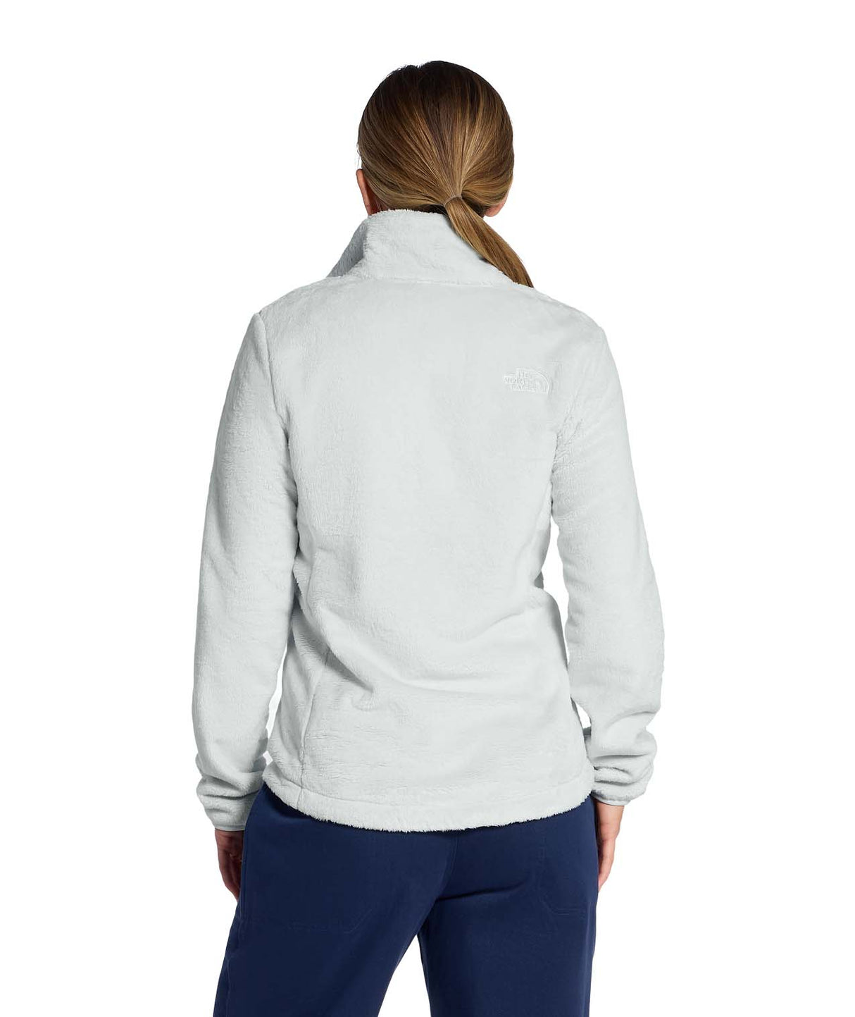 WOsitoJacket- Woman wearing a beige full zip fleece jacket with a brand logo on a white background