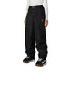 WOutlineShellPant-Person wearing black snow pants with a white heart stitched under the left front pocket on a white background