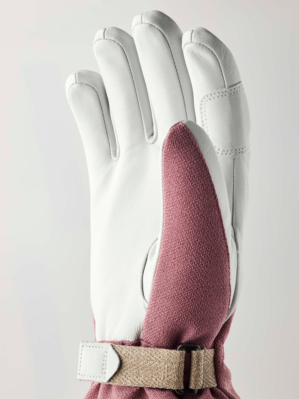 WPatrolGauntletGlove-Pair of pink and white gloves with a visible brand logo on a white background