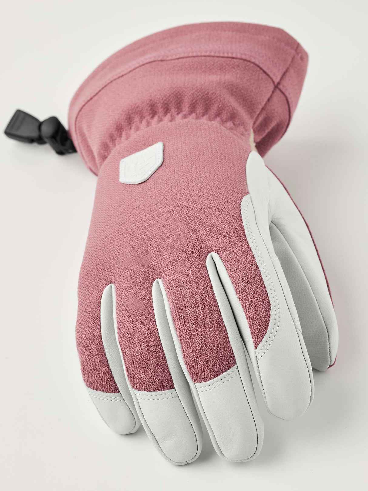 WPatrolGauntletGlove-Pair of pink and white gloves with a visible brand logo on a white background