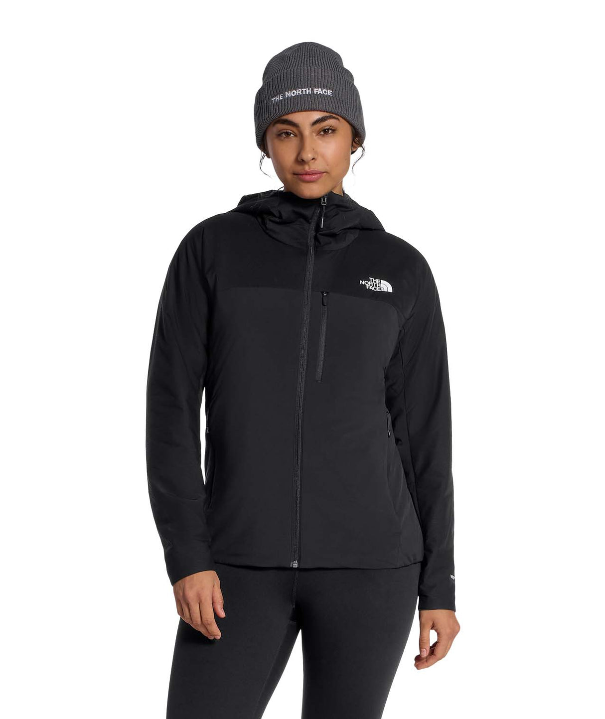 WSummitCasavalHoodie-Person wearing a black jacket and beanie with The North Face logo on a white background
