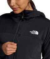 WSummitCasavalHoodie-Person wearing a black The North Face jacket with a white logo on a white background