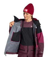 WSummitVerbierGTXJacket-Person wearing a maroon and black jacket with a red beanie.