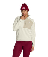 WTNFPerformanceFleece1_4Zip- Person wearing a beige and brown color-blocked jacket with a red beanie on a white background